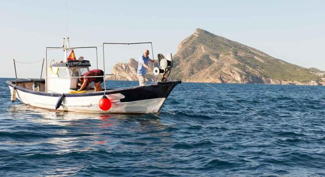 Tratamiento contable de una tarifa de pesca. Barca de pesca en el mar