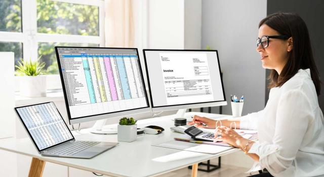 Aspectos  importantes a la hora de configurar un programa contable. Imagen de mujer con dos ordenadores con aplicaciones contables. Configuración
