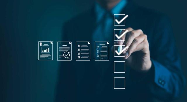 Publicado el nuevo compendio de Normas NIA-ES y NIGC: Guía completa del ICAC. Imagen de un hombre chequeando un listado